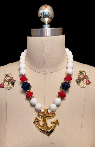 *VINTAGE 1980s NAUTICAL METAL ANCHOR NECKLACE AND EARRINGS WITH FLAG, ANCHOR AND SAILBOAT DANGLING FROM A LIFE PRESERVER