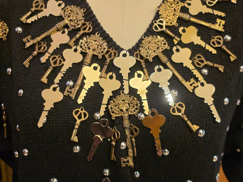BONNIE BOERER & COMPANY 1980S BLACK RAMIE - COTTON SWEATER WITH GOLD KEY MOTIF AND SILVER STUDS