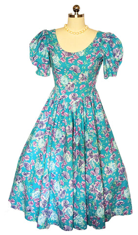 *   VINTAGE LAURA ASHLEY COTTON AQUA AND PURPLE FLORAL GORED GRAND SWEEP DRESS WITH BOW IN BACK MADE IN GREAT BRITAIN