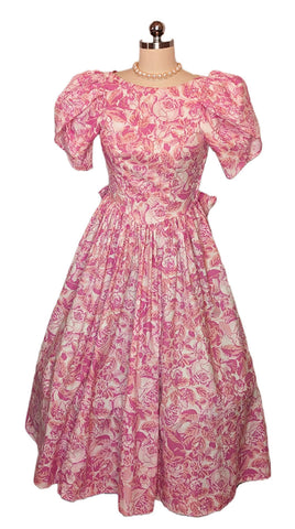 *   VINTAGE LAURA ASHLEY COTTON ROSE AND PINK FLORAL GORED GRAND SWEEP DRESS WITH HUGE BOW AND STREAMERS MADE IN GREAT BRITAIN